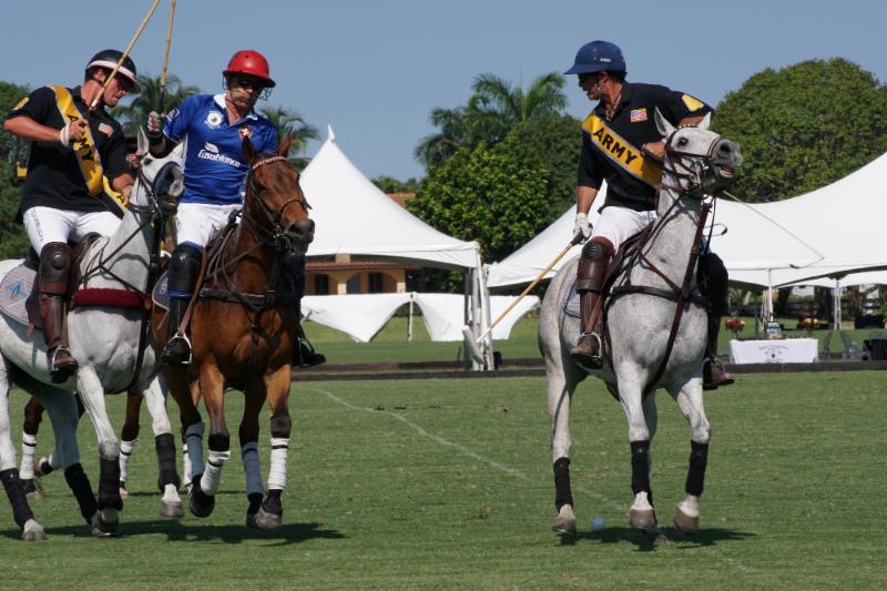 Army teammates Jesse Bray and Juan Bollini defends Markus Graff of Grand Champions. Photo courtesy ChukkerTV.
