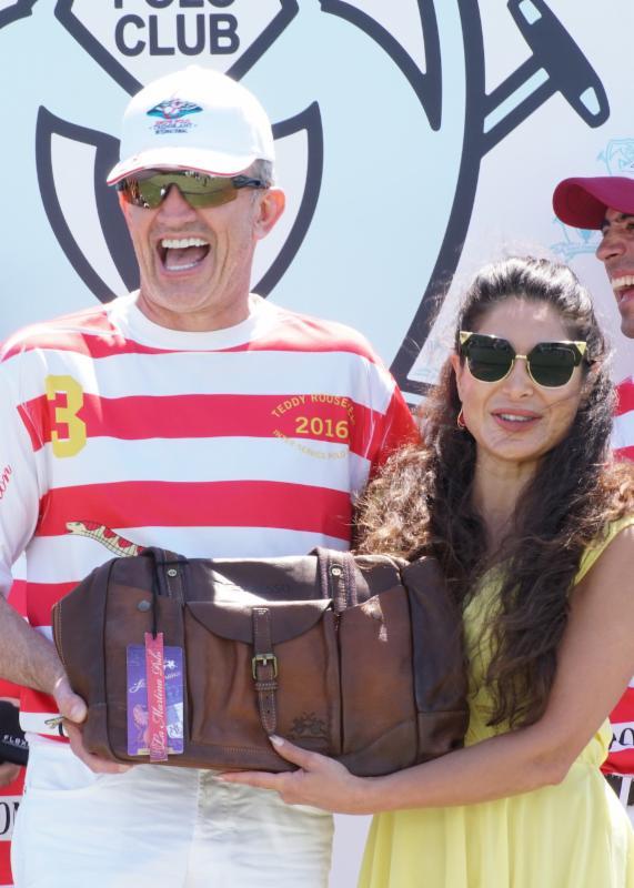 MVP Paul Knapp receives his MVP plaque from award-winning actress and model Saye Yabandeh. Photo courtesy ChukkerTV.