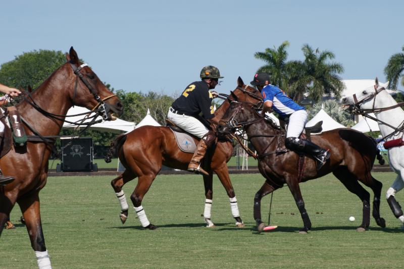 Terrence Donahue of Army hits past defender Pablo Dorignac of Grand Champions. 