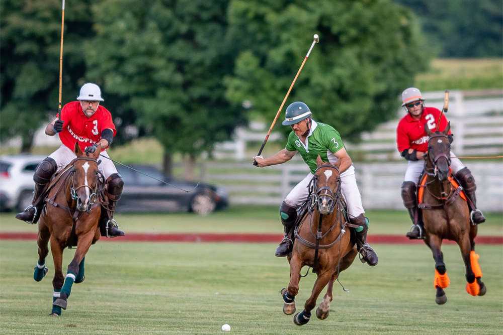 Dean Kleronomos of Morgan Creek Farm chasing after Billy Mudra riding Thing 2 in the Chicago Polo 4-6 goal league.©John Sterndish