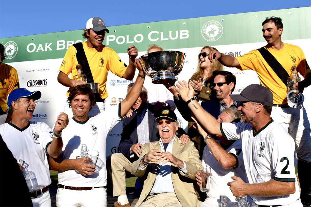 Players celebrate after U.S. Open Polo Championship® Alumni Match. Top row: Del Walton, Jim and Peggy Drury, Bob and Marci Puetz, Martin Ravina. Bottom row: Martin Estrada, Luis Escobar, Michael Butler, Joel Baker, Mika Azzaro. ©Judith Coleman. 