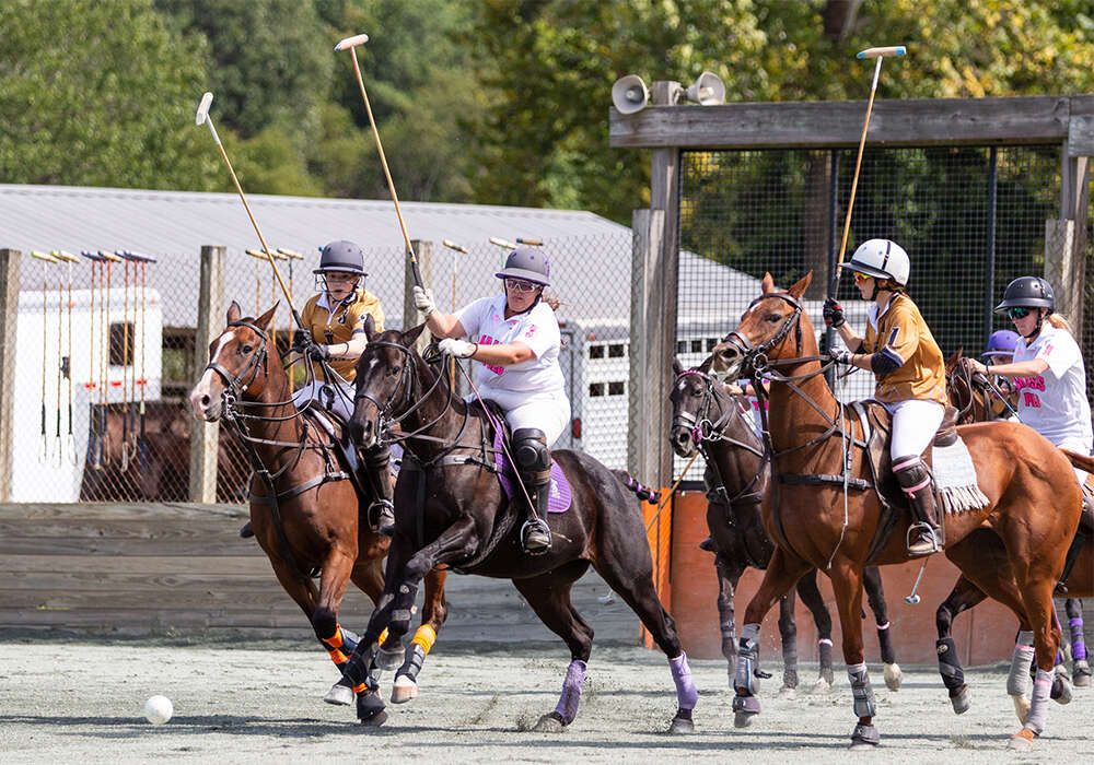 La Jefa's Jessica Schmitt and Bad Ass Polo's Demitra Hajimihalis race to make a play on the ball.