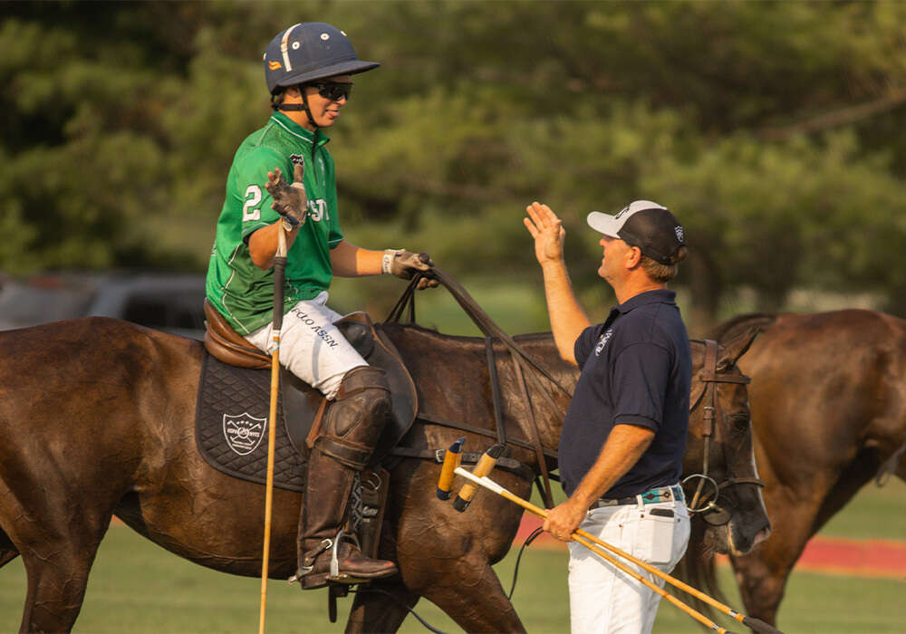 Eastern's Aiden Meeker high-fiving coach Tiger Kneece. ©Kaile Roos