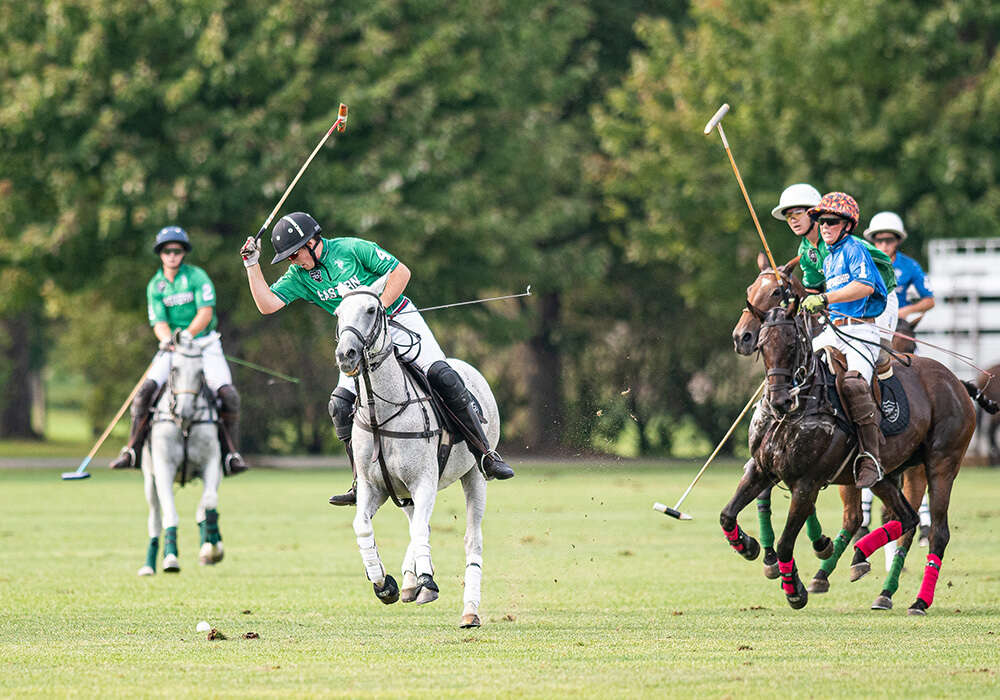 Eastern's Landen Daniels attempts a backhand with space between his competitors on the field. ©Andrew Meier