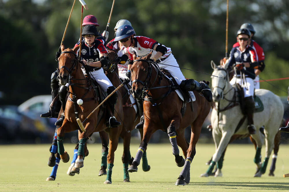 England's Ned Hine carries the ball with USA's Olivia Uechtritz in pursuit.