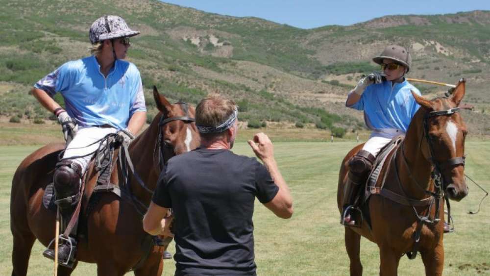 Former 10-goaler Mike Azzaro coaching sons Harrison and Hunter between chukkers.