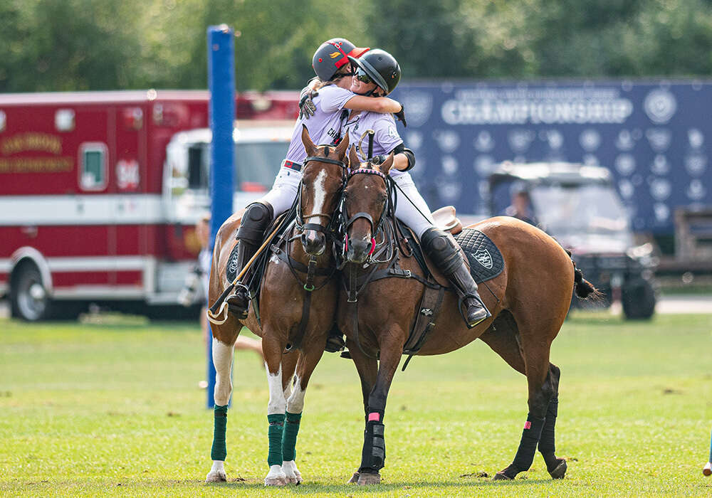 Girls' Purple Elise Pardue and Summer Kneece embrace after their finals victory. ©Andrew Meier
