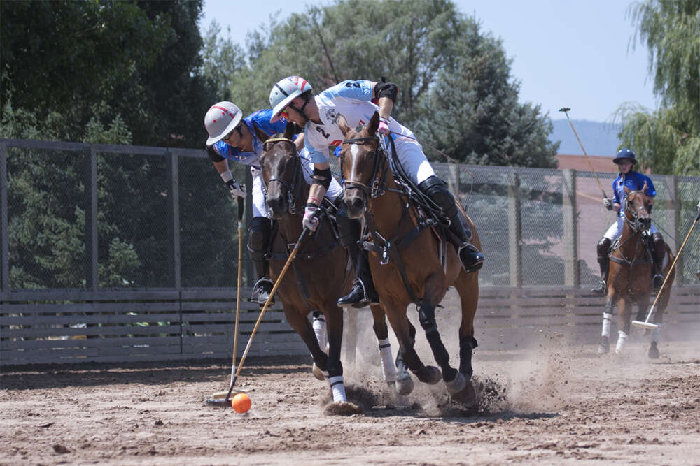 Grant Ganzi of Casablanca keeps possession with Carlitos Gracida of The Polo School defending.