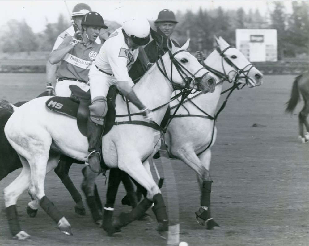In the January 14 - Sunshine League game between Barrington Hills and BellSouth Mobility, Mike Sparks hit the ball as both Robert Evans and Bart Evans look on.(43362) ©Museum of Polo web