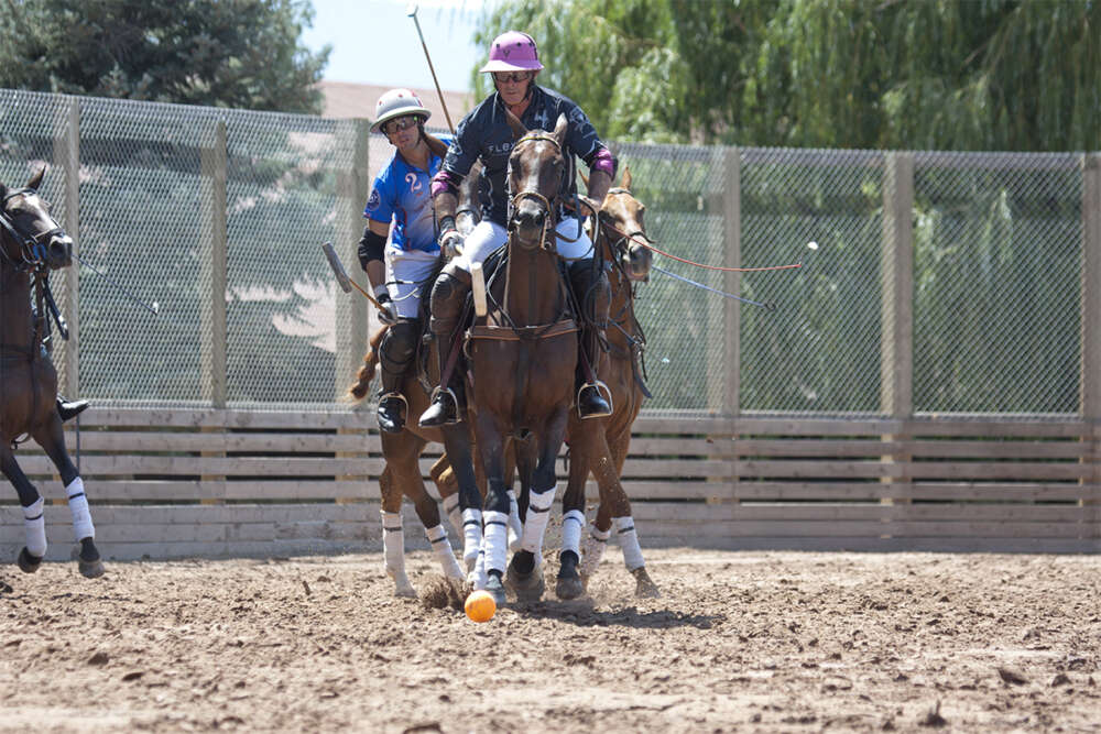 Juan Bollini of Flexjet follows up his hit ball with Carlitos Gracida of The Polo School close behind.