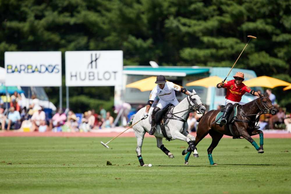 Work to Ride/Los Machitos's Mariano Aguerre carries the ball down field with Phoenix's Victorino Riz Jorba on his hip. 