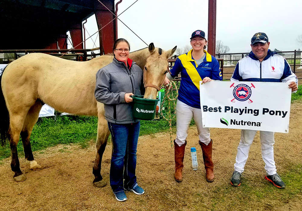 Megan Mitchell of Jackrabbit Tack presents the Best Playing Pony award to John Wayne, played by Amanda Massey and owned by Javier Insua.