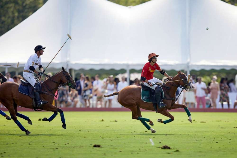Phoenix's Victorina Ruiz Jorba keeps his eye on the ball with Work to Ride/Los Machitos' Nick Manifold riding close behind.