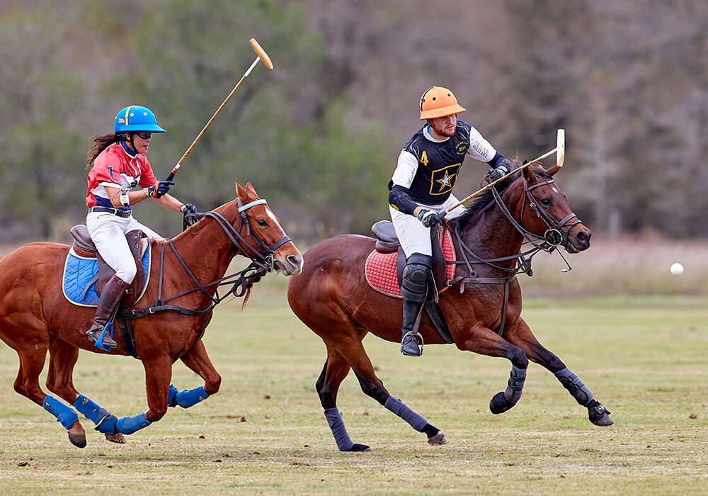 Oak Bend Farm's Jessica Mignone and Shweiki Media's James Glew race for possession.