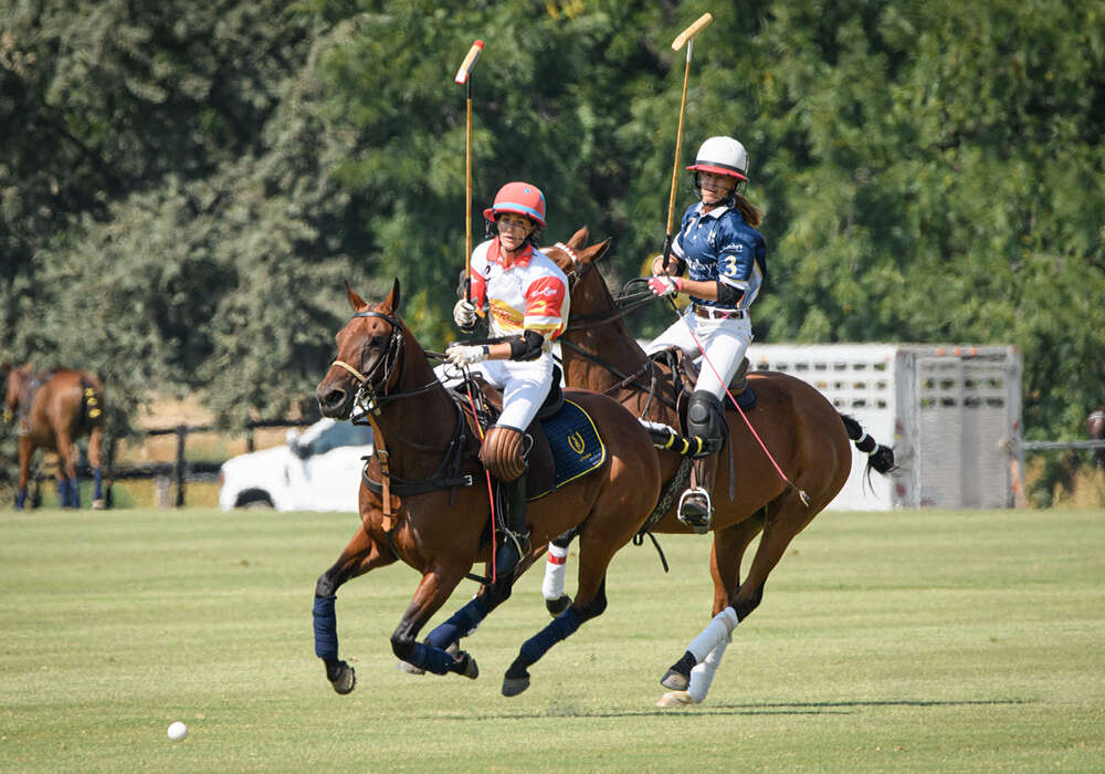 Topo Chico's Meghan Gracida sets her eyes on the ball with Sotheby's Dayelle Fargey close behind.