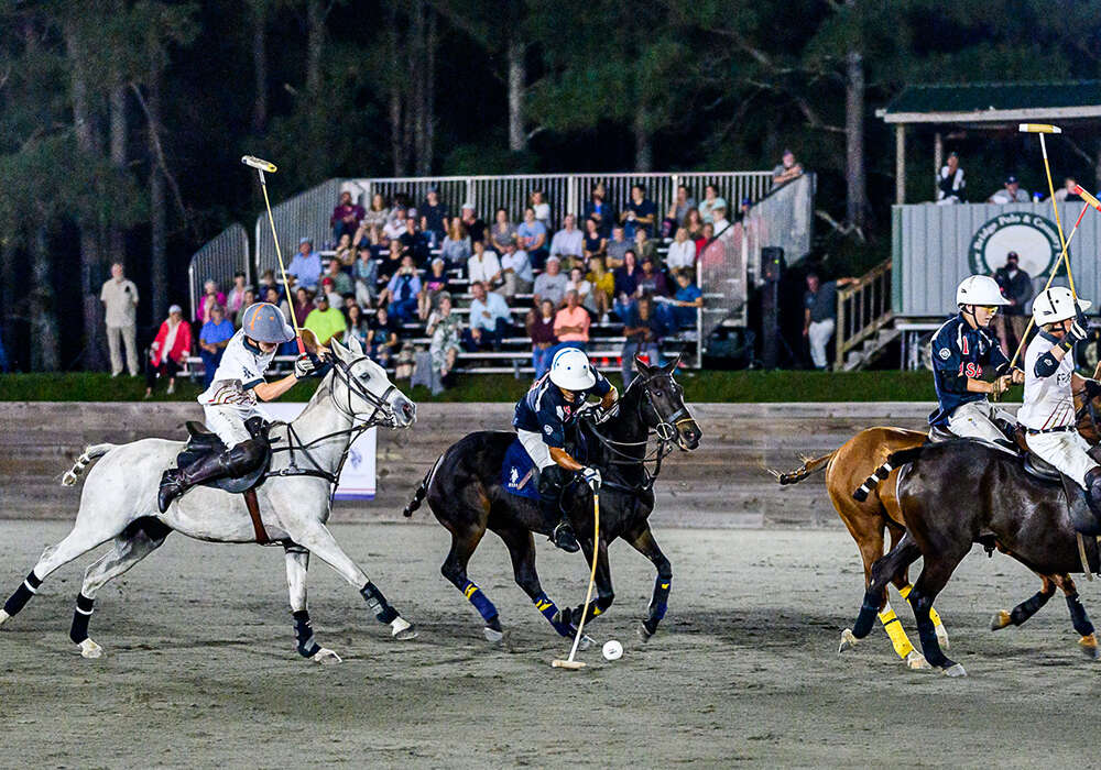 USA's Pelon Escapite plays the balll ahead of a charging England's Robin Ormerod.