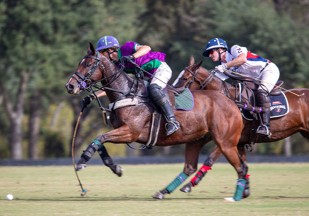 Vintage Polo's Cody Ellis reaches for the ball ahead of Rocking P's Grayson Price.