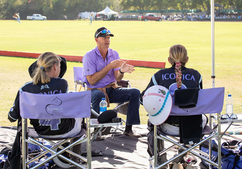 Iconica coach Julio Arellano discussing strategy with Kylie Sheehan and Hope Arellano.