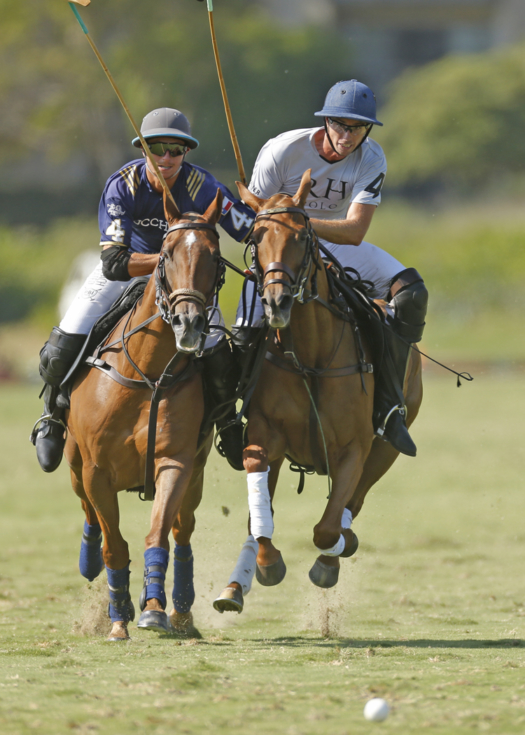Lucchese's Jared Zenni and Restoration Hardware's Santi von Wernich gallop to the ball at full speed. 