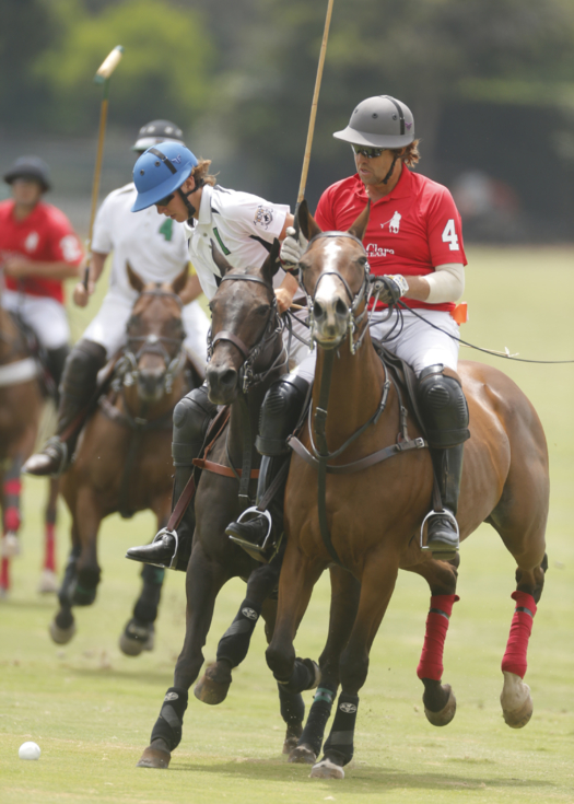 Father and son battle for possession. Farmer & Merchants Bank's Nico Escobar in white, Santa Clara's Luis Escobar in red.