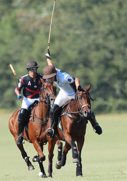 Orchard Pond-Un-Stable's Sterling Giannico riding Best Playing Pony Tequila, takes the ball downfield ahead of La Bourgogne's Alan Martinez.