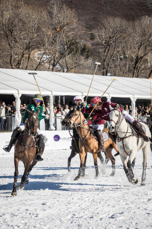 Players battle for the ball in the final of the St. Regis World Snow Polo Championship.